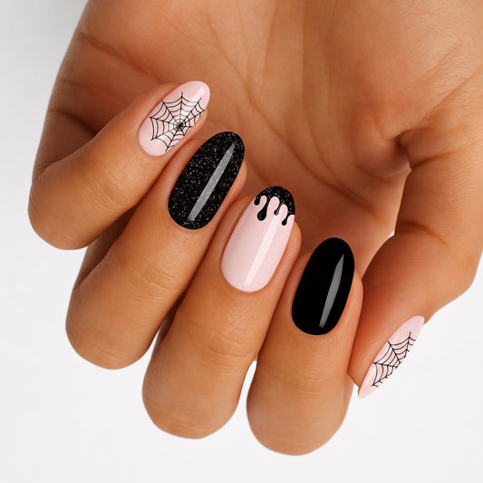Semi-cured gel nail wraps in glossy pink and black with spiderweb and drip Halloween design