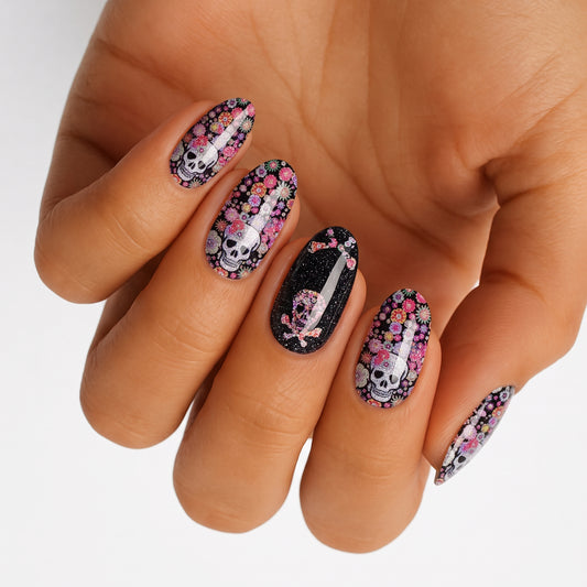 Black nail wraps with sugar skull and floral print, glitter accent nail with dagger design