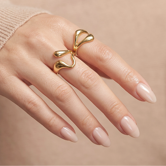 Sheer nude semi-cured gel nail wraps in glossy finish on almond-shaped nails