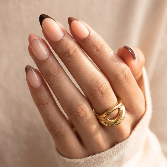 Glossy nude nail wraps with brown French tip on almond-shaped nails
