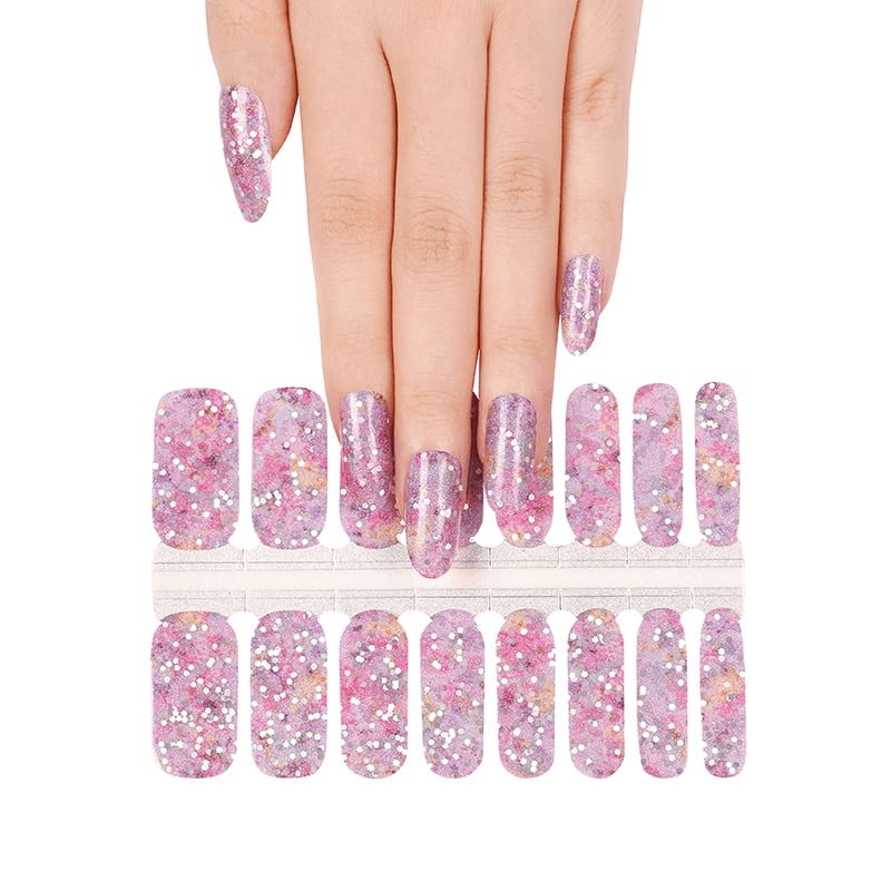 Purple glitter nail wrap sheets with hand showing applied sparkly manicure