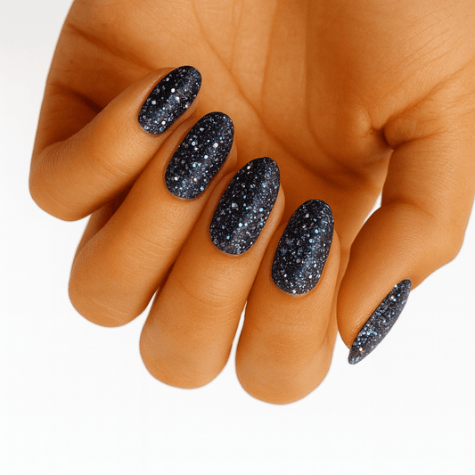 Black glitter nail wraps with sparkly galaxy design on hand manicure