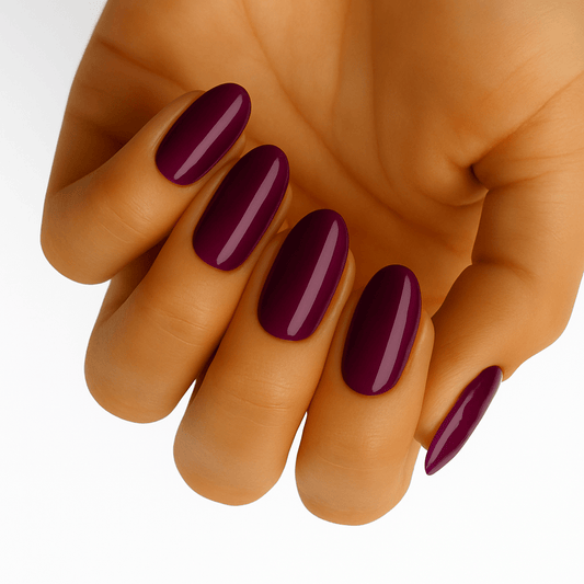 Deep burgundy glossy gel nail wraps on hand showing classic wine red manicure