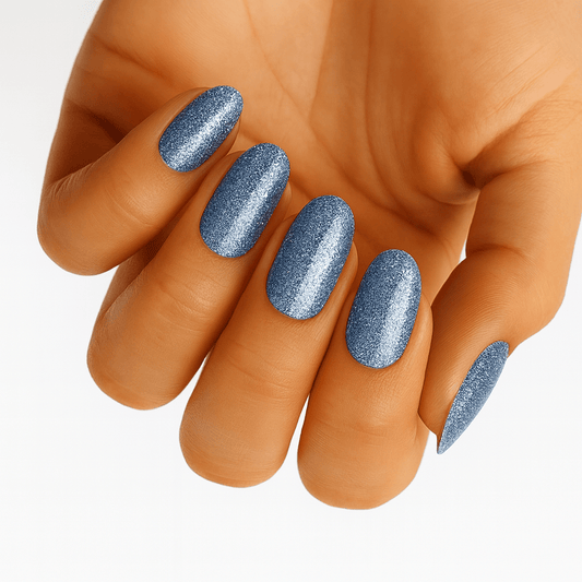 Hand showing blue glitter nail wraps with shimmer metallic finish manicure