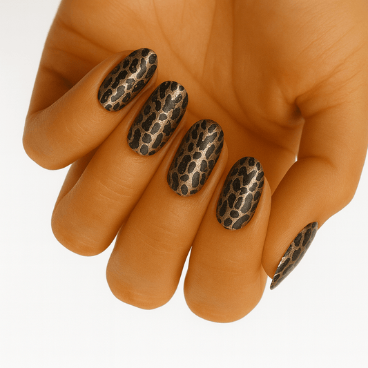 Leopard print nail wraps on hand showing brown and black animal print design