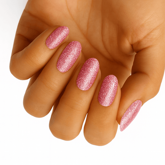Hand wearing pink glitter gel nail wraps with sparkly shimmer finish manicure