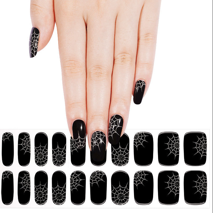 Glossy black semi-cured gel nail wraps with white spiderweb Halloween design