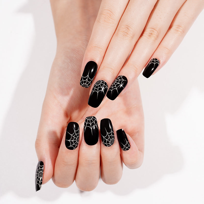 Glossy black press-on nails with white spiderweb design, square shape, Halloween style