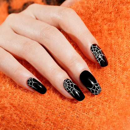 Glossy black nail wraps with white spiderweb accents, coffin shape, Halloween design