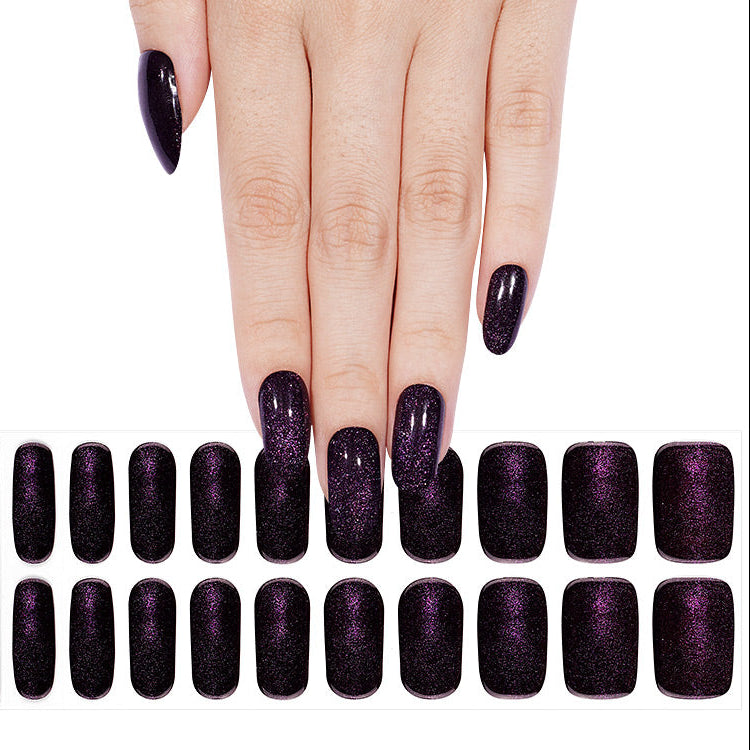 Black nail wraps with purple shimmer, glossy finish, almond-shaped semi-cured gel set.
