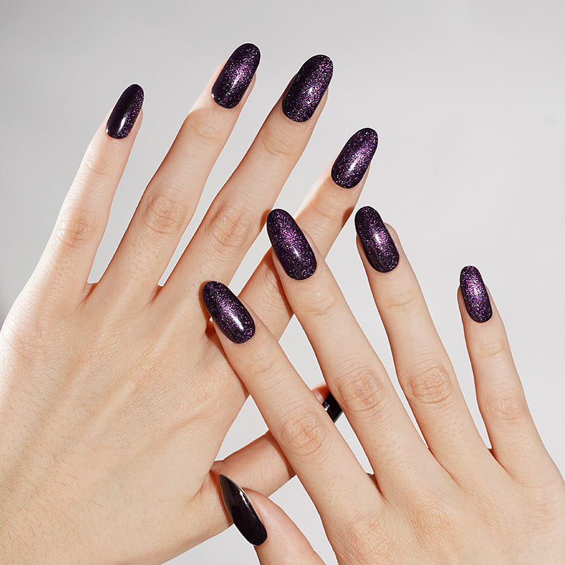 Deep purple-black shimmer nail wraps with fine glitter on almond press-ons.