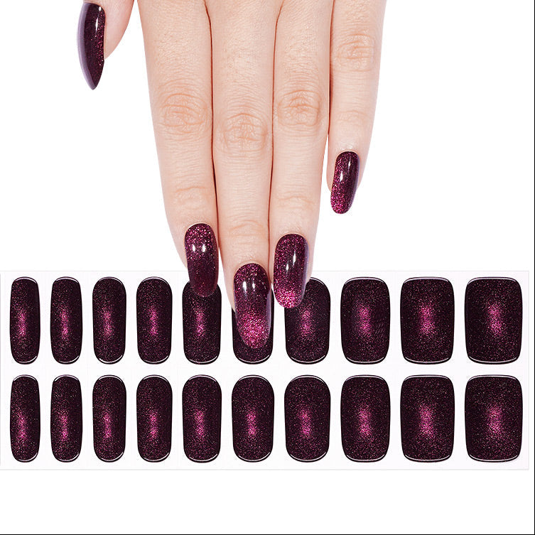 Deep burgundy semi-cured gel nail wraps with cat-eye magnetic pink shimmer effect