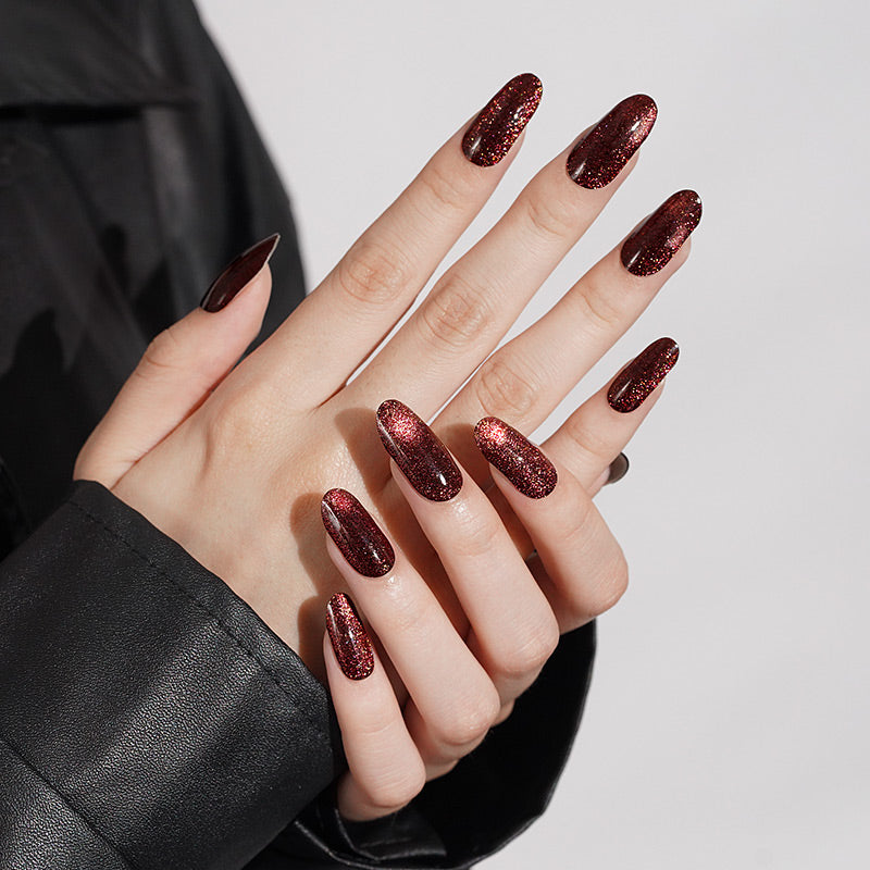 Deep red glittery press-on nails, glossy finish, long almond shape