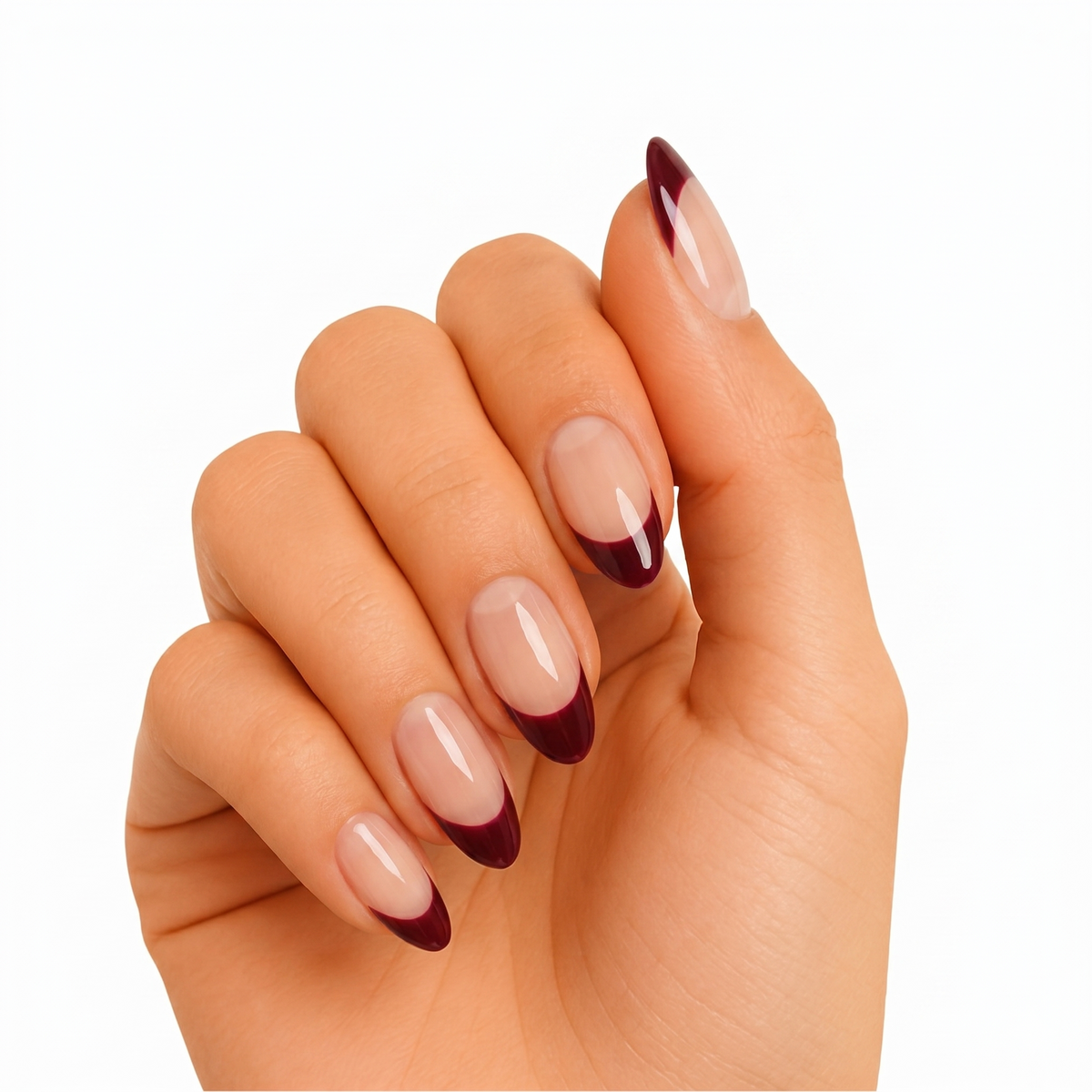 Glossy nude nails with dark burgundy French tip design on almond shape