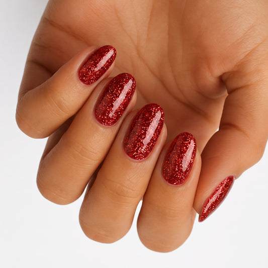 Red glitter semi-cured gel nail wraps on almond-shaped nails, glossy sparkling finish.