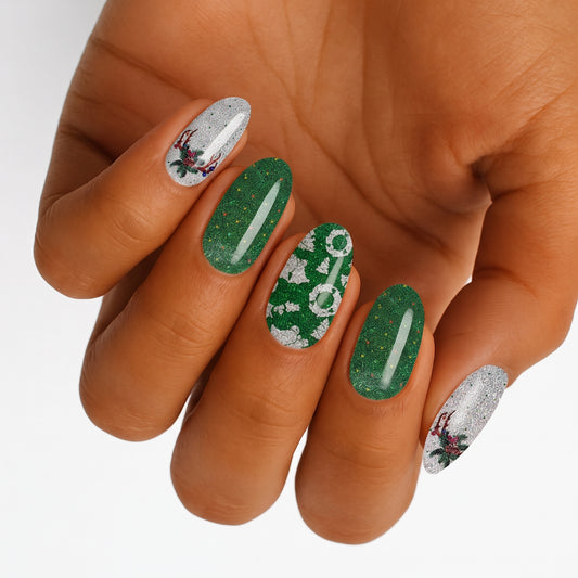 Glittery green and silver nail wraps with Christmas trees, wreaths and holly motifs