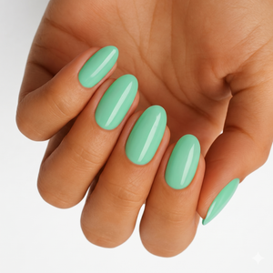 Solid mint green glossy semi-cured gel nail wraps on almond-shaped nails.
