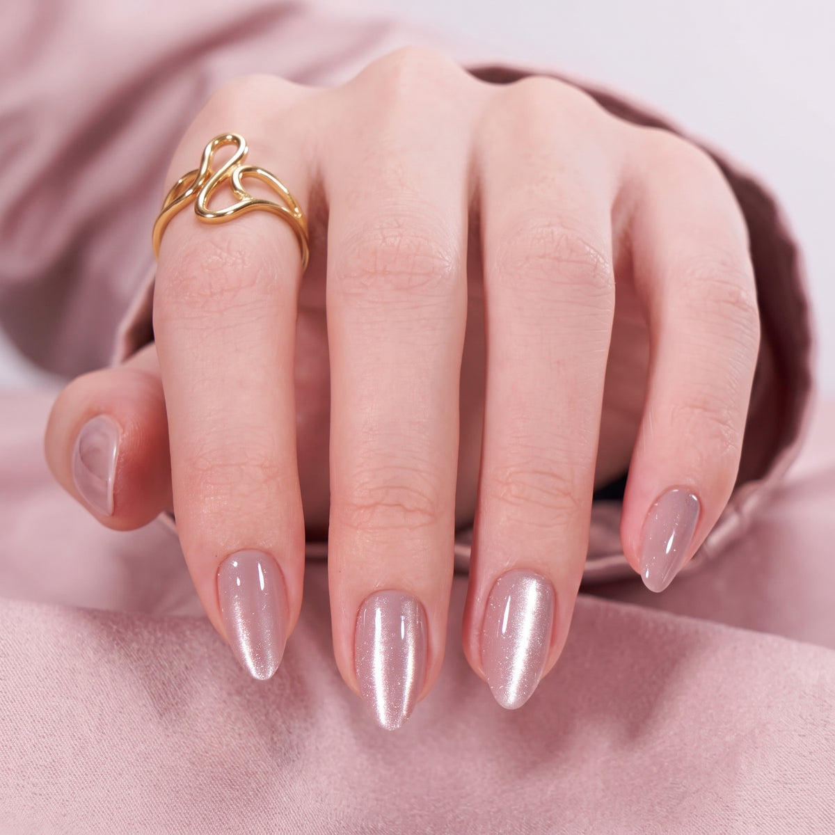 Sheer mauve-pink shimmer semi-cured gel nail wraps on almond-shaped nails