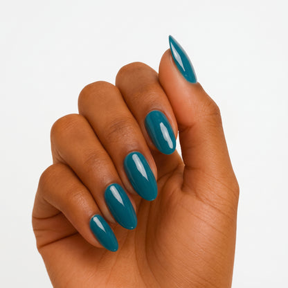 Solid teal glossy semi-cured gel nail wraps on almond-shaped nails, close-up hand pose.