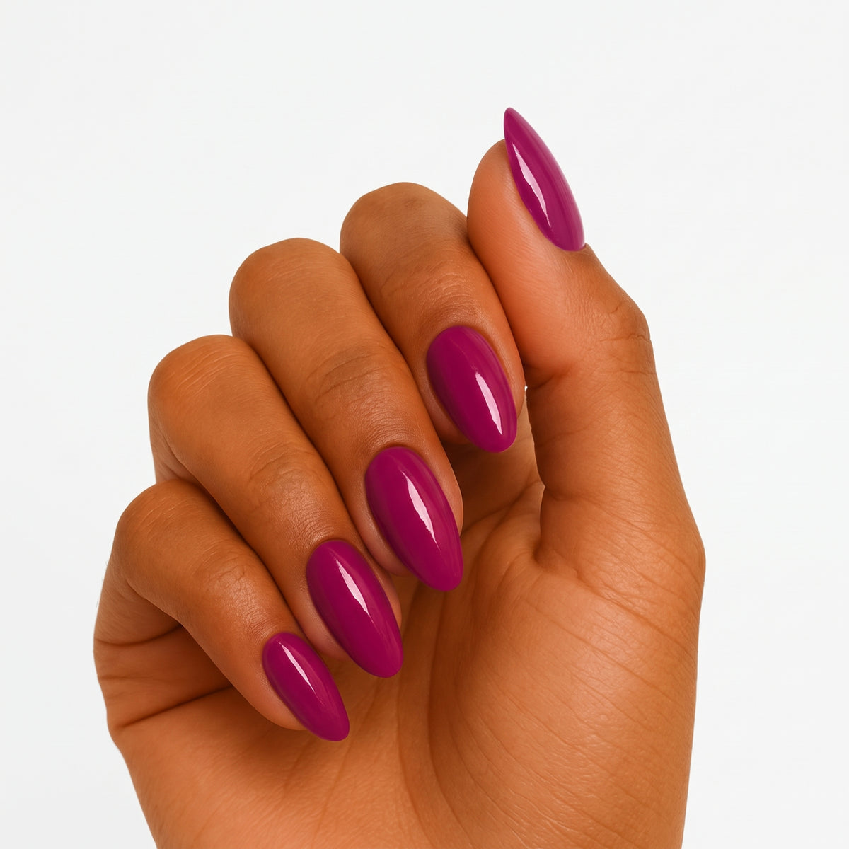 Glossy magenta-purple semi-cured gel nail wraps on almond-shaped nails, solid colour finish