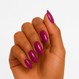 Glossy magenta-purple semi-cured gel nail wraps on almond-shaped nails, solid colour finish
