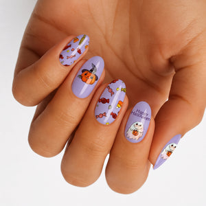 Lavender press-on nails with Halloween candy, pumpkin, ghost, and "Happy Halloween" text designs