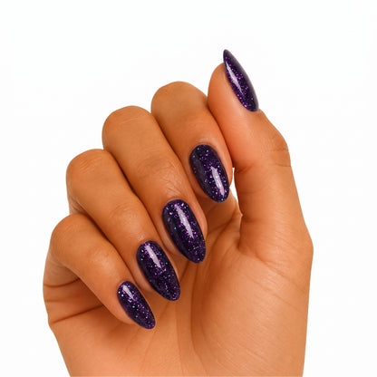Deep purple glitter semi-cured gel nail wraps on almond-shaped nails, glossy finish.