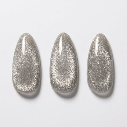 Grey soft gel press-on nails with shimmering cat's eye glitter effect, medium almond shape