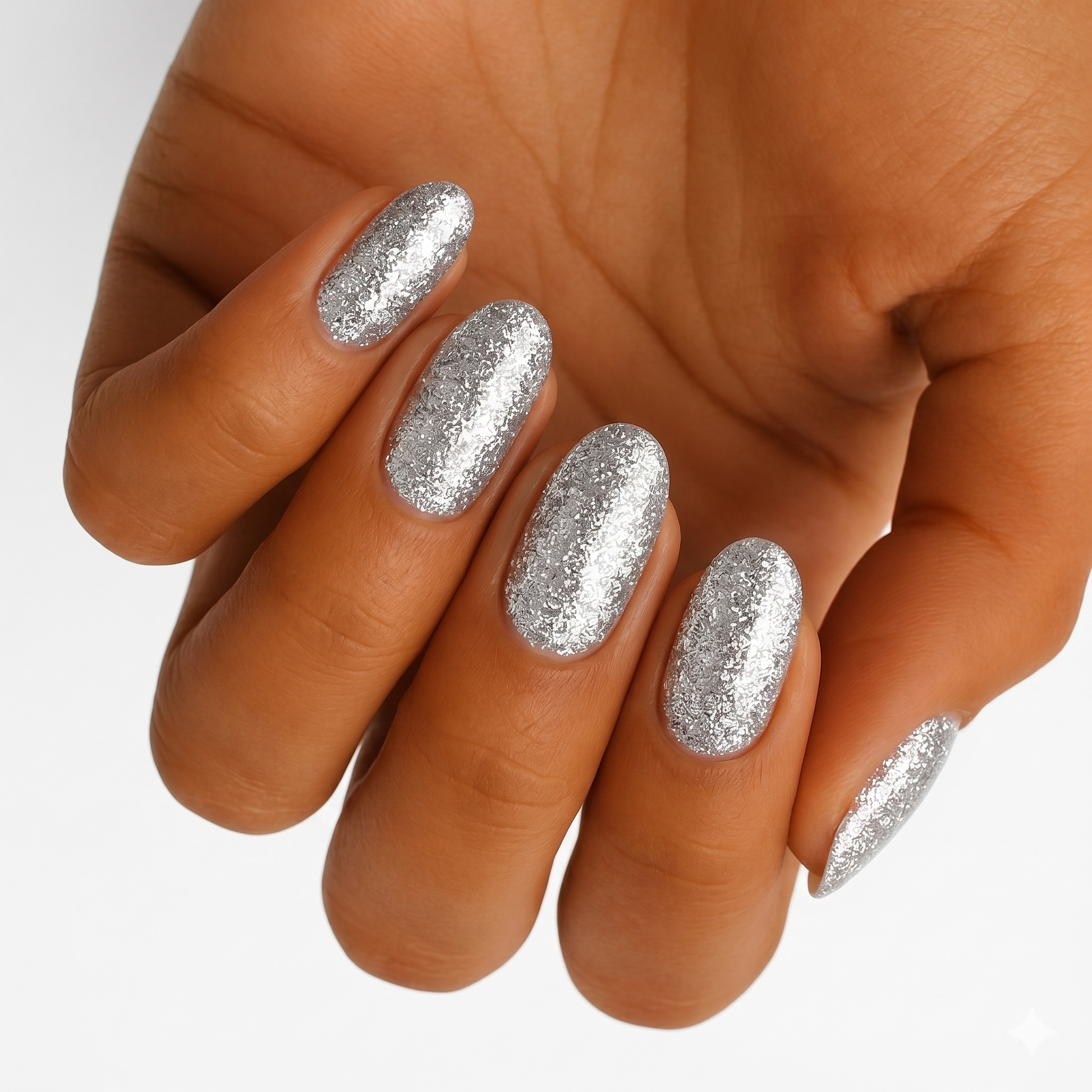 Sparkly silver glitter gel nail wraps on hand showing glamorous metallic shine