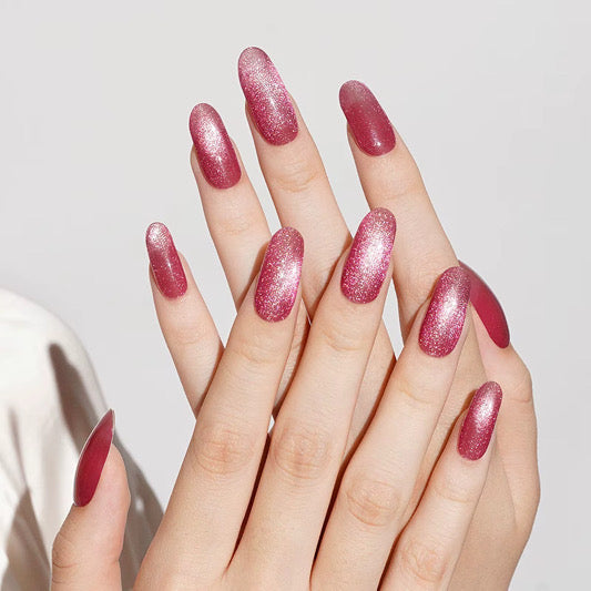 Rose pink shimmer semi-cured gel nail wraps with glitter finish on almond-shaped nails.