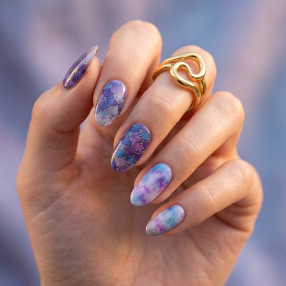 Purple and blue mermaid scale nail wraps with glittery marble accent nails on almond shape.