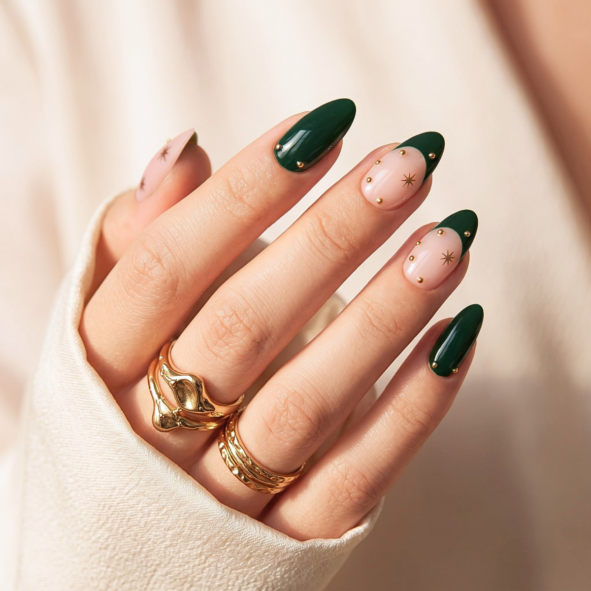 Glossy dark green French tip press-on nails with gold star and stud accents