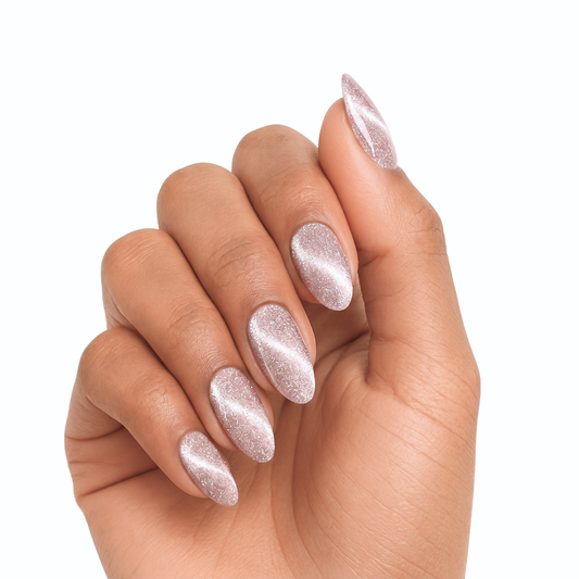 Almond press-on nails in shimmering pink-champagne with cat-eye holographic sparkle finish