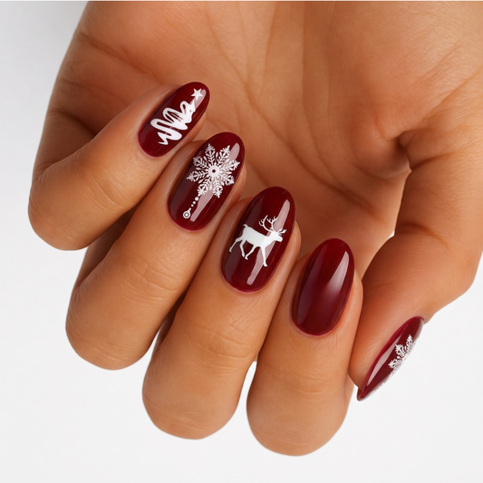 Deep red glossy nail wraps with white Christmas tree, snowflake and reindeer designs