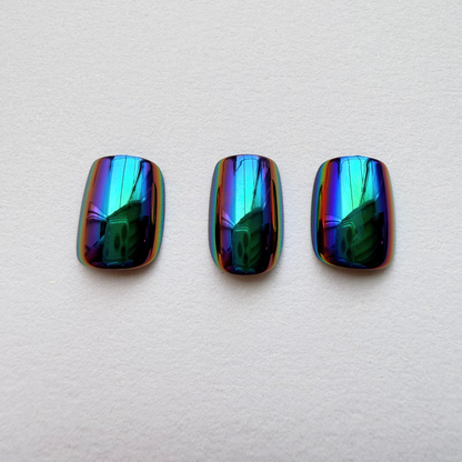Oil-slick chrome press-on nails with iridescent blue, green and purple mirror finish.