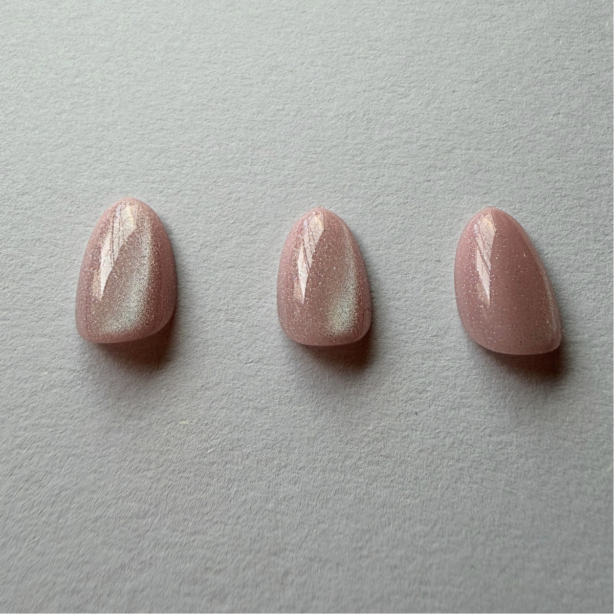 Mauve pink shimmer press-on nails, short round shape, glossy finish