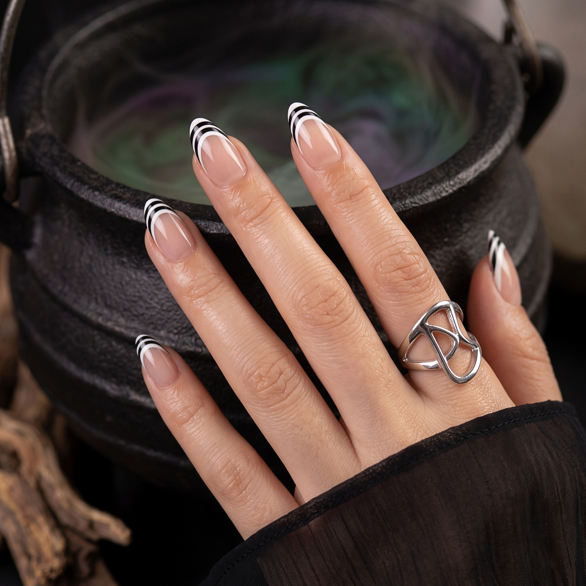 Nude semi-cured gel nail wraps with glossy black and white striped French tips