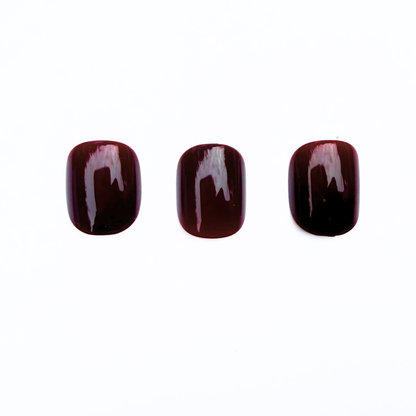 Deep burgundy glossy press-on nails, semi-cured gel, solid dark wine shade.