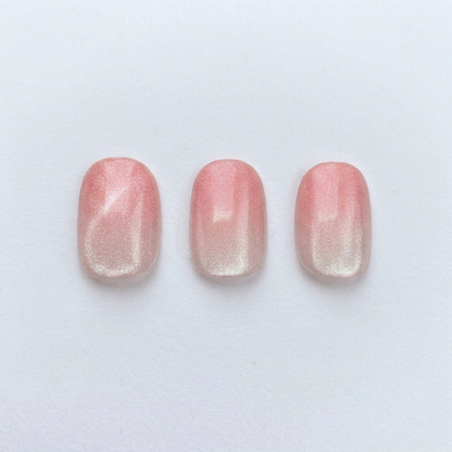Pink shimmer press-on nails with sheer ombre fade, glossy finish