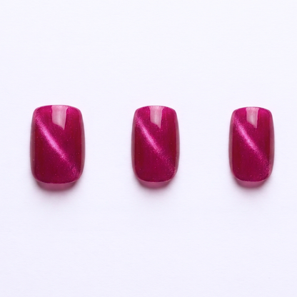 Magenta pink press-on nails with cat-eye shimmer effect, glossy finish