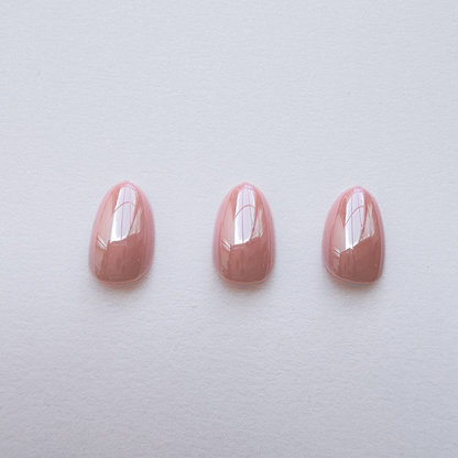 Glossy mauve-pink press-on nails, solid color, almond shape, three nail set