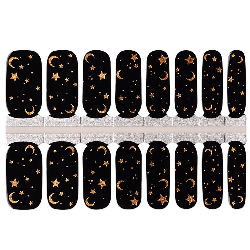 Black semi-cured gel nail wraps with gold moon and star celestial night sky design