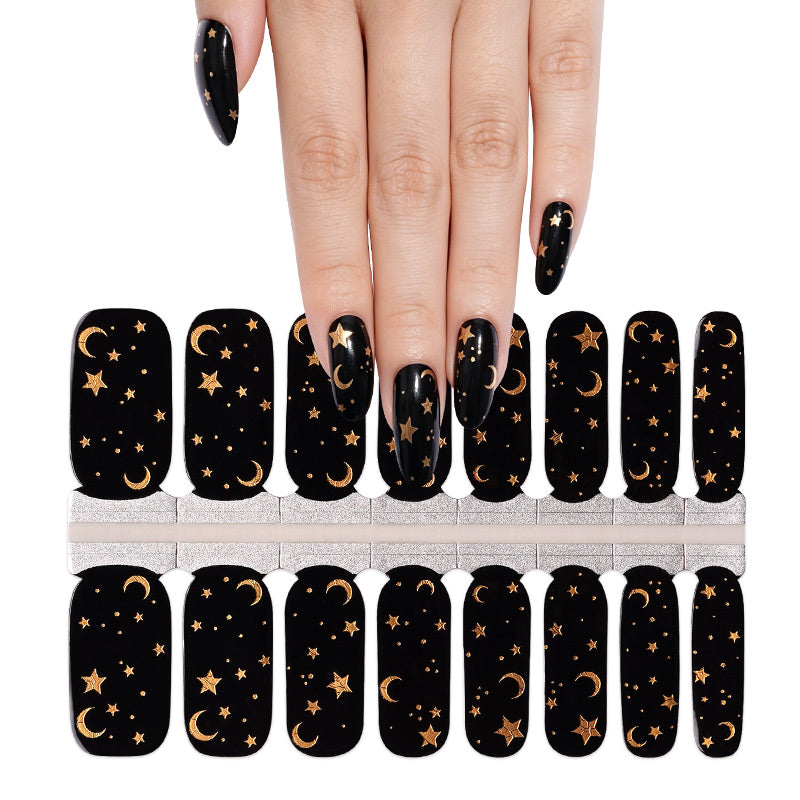 Black glossy semi-cured gel nail wraps with gold moon and star night sky design