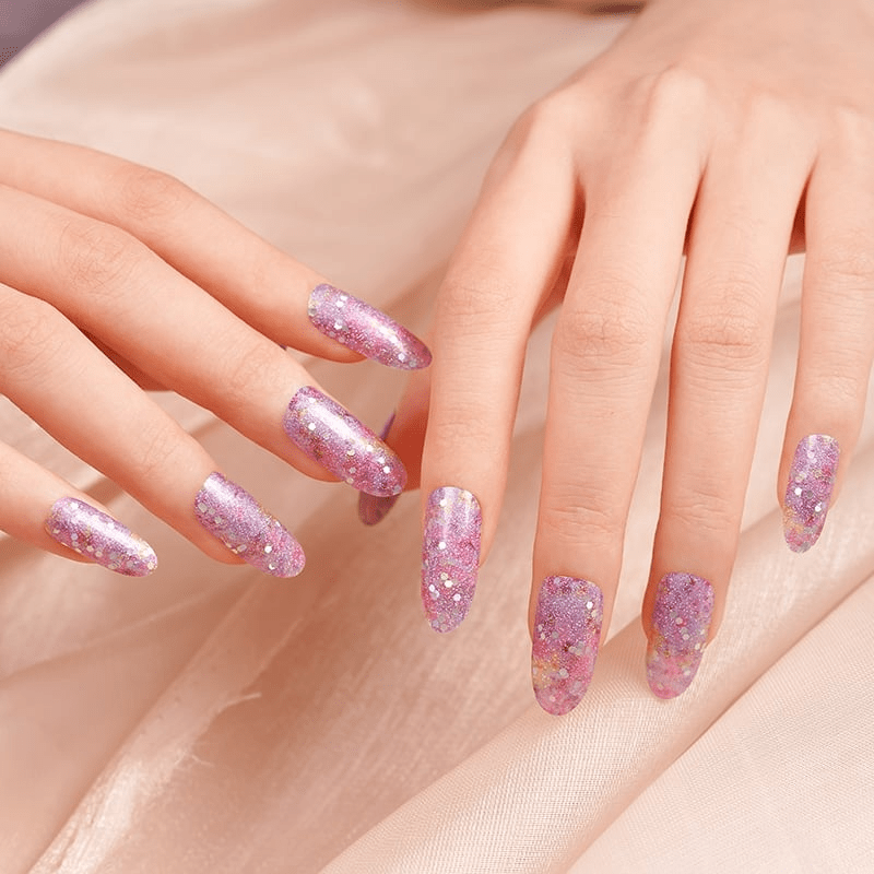 Both hands displaying purple glitter nail wraps with sparkly finish