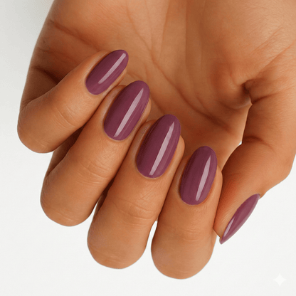 Glossy blackberry purple nail wraps on hand showing deep plum manicure finish
