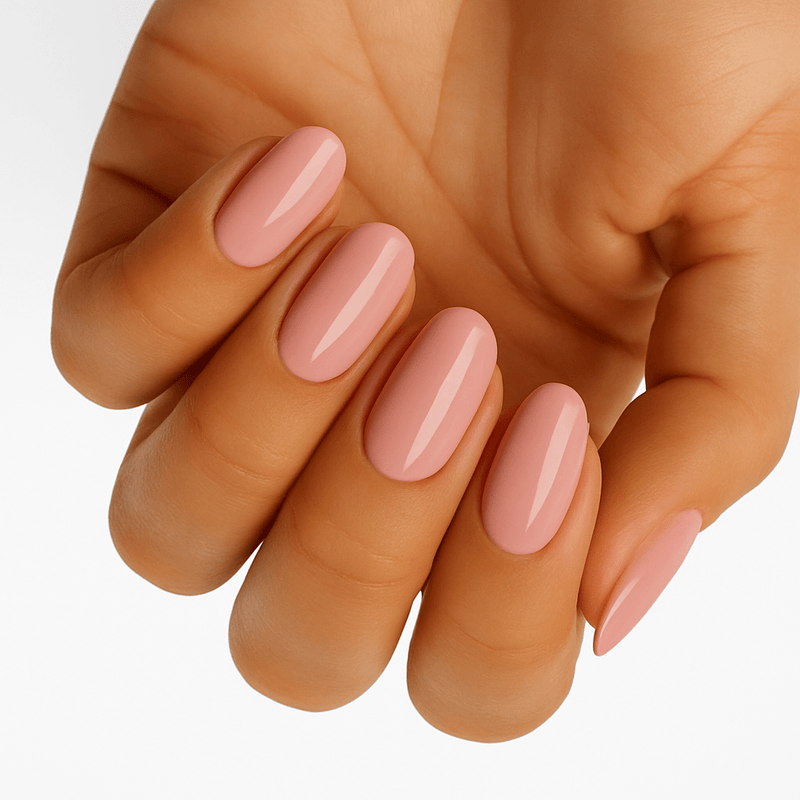 Glossy peach pink gel nail wraps applied on hand showing elegant solid colour manicure finish