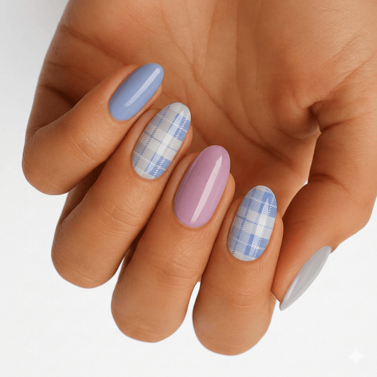 Blue pink tartan plaid nail wraps on hand showing Scottish crosshatch pattern manicure