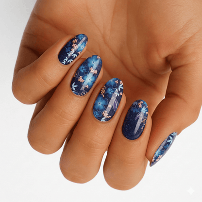 Blue tropical floral nail wraps on hand showing watercolour botanical design