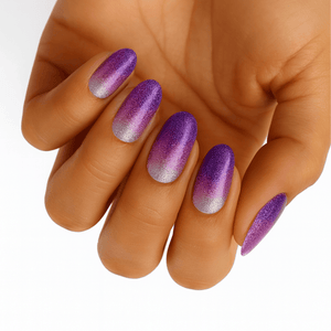 Purple glitter ombre nail wraps on hand fading from violet to silver