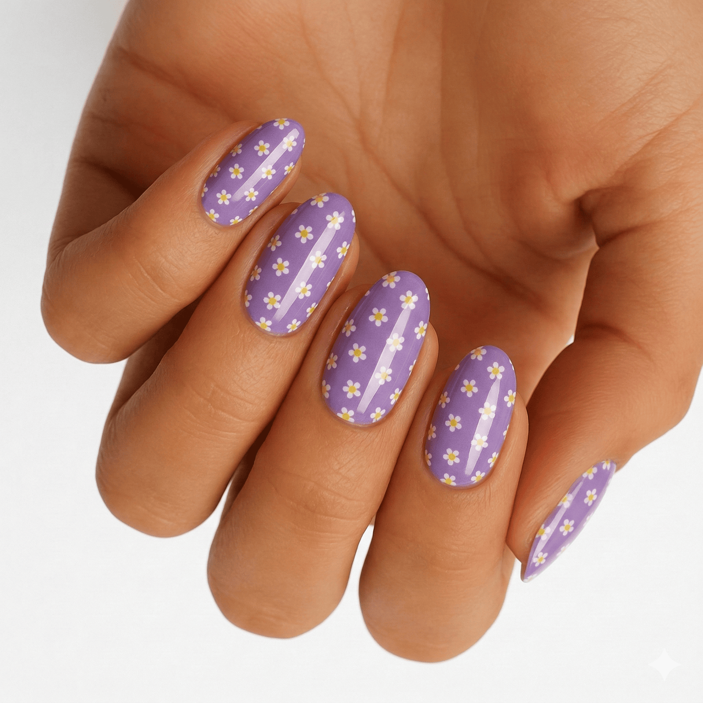 Purple glitter nail wraps with yellow buttercup flowers worn on hand